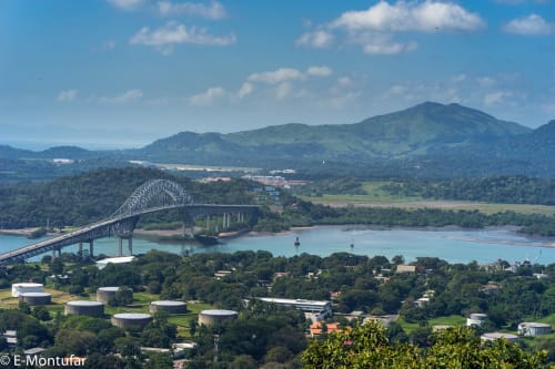Aerial view of El Litoral Wellness Retreat with bridge, river, and lush mountains in Panama countryside