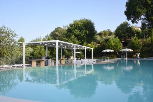 Luxurious swimming pool with white pergola at Country House Bosco d'Olmi, Sant'Andrea del Garigliano, surrounded by lush