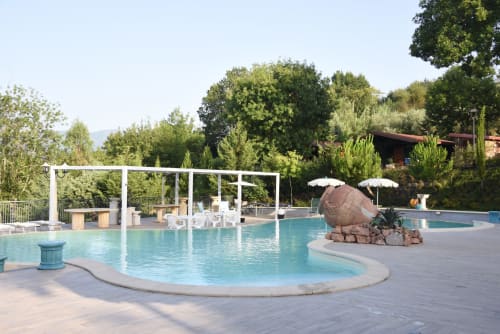 Resort pool area at Country House Bosco d'Olmi with loungers, umbrellas, and garden views in Sant'Andrea del Garigliano,
