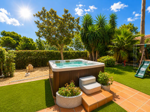 Hot tub on terrace at Casa Emilia villa in Moraira with tropical garden and palm trees