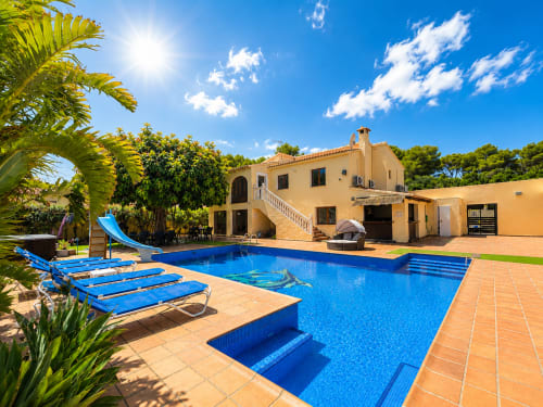 Casa Emilia villa in Moraira with sparkling blue swimming pool, sun loungers, and Mediterranean architecture