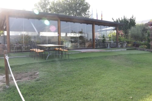 Country House Bosco d'Olmi terrace with dining area overlooking green lawn and mountains, Sant'Andrea del Garigliano