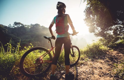 Cyclist pausing on woodland trail near Country House Bosco d'Olmi in Sant'Andrea del Garigliano, Italy