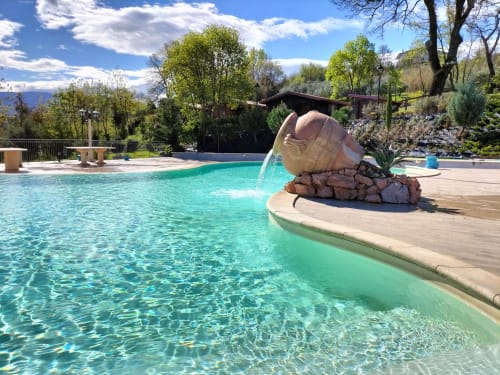 Turquoise pool with stone water feature at Country House Bosco d'Olmi, Sant'Andrea del Garigliano