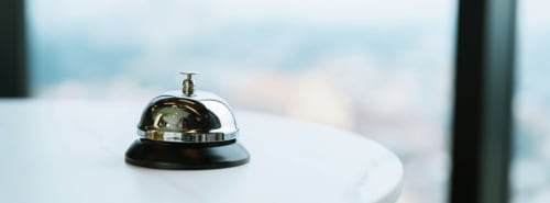 Polished service bell on white desk at Mas le Châtelet hotel in Saint Paul de Fenouillet
