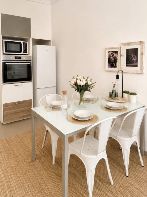 Modern kitchen-dining area at Veneto Villa with white table, chairs, and equipped kitchenette in Sant'Agostino