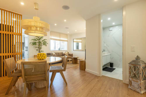 Modern Sea'Ya Villas apartment in Cascais with dining area, living room, kitchen, and bathroom entrance