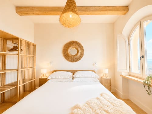 Bright Panoramic Suite at Tuscan Townhouse with wooden beams, woven accents, and garden views from arched windows