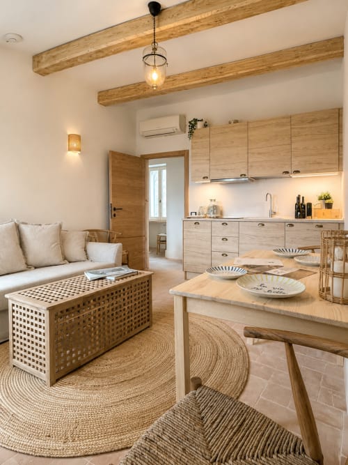 Bellavista Suite at Tuscan Townhouse - open-plan kitchen and dining area with wooden beams, light wood cabinetry, and rustic