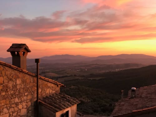 Tuscan sunset view from Terrace Suite balcony at Montemassi townhouse with countryside landscape