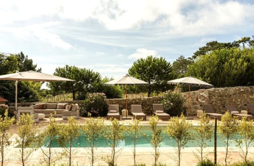 Sea'Ya Casa Pavão villa pool view in Colares with loungers, umbrellas, and Mediterranean landscape