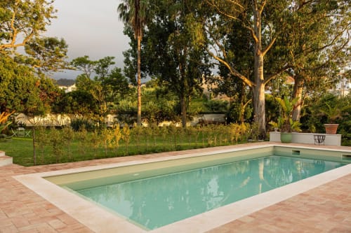 Private pool at Sea'Ya Casa Pavão villa in Colares, surrounded by lush gardens and tall trees