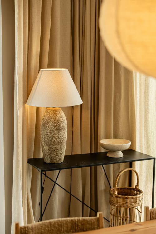 Elegant villa entryway with textured lamp, wooden bowl, wicker basket, and beige curtains at Sea'Ya Casa Pavão