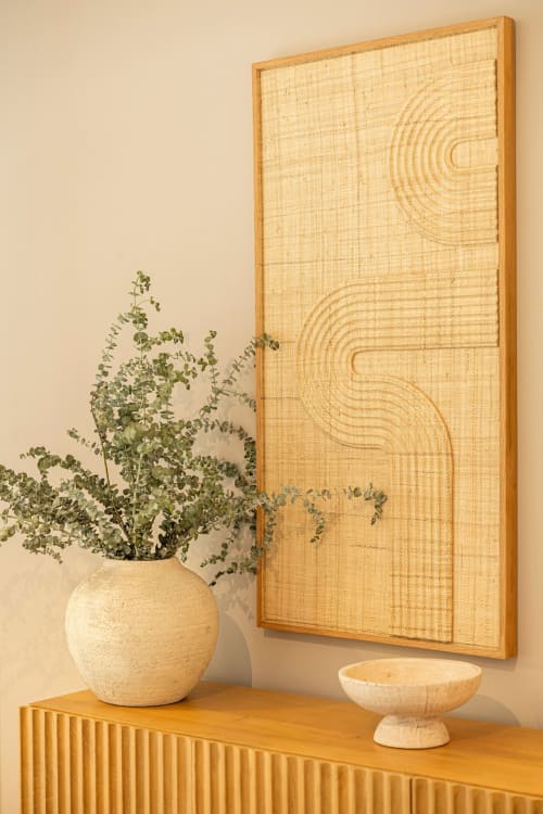 Wooden wall art with geometric patterns above wooden console table with potted plant at Sea'Ya Villas villa in Colares,