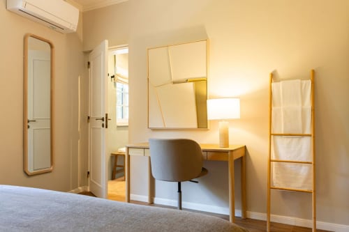 Modern bedroom desk with mirror and chair at Sea'Ya Casa Pavão villa in Colares, Portugal