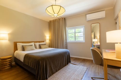 Spacious Sea'Ya Casa Pavão villa bedroom in Colares with wooden furniture, neutral tones, and modern amenities