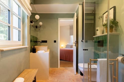 Modern ensuite bathroom at Sea'Ya Casa Pavão villa in Colares with green tiled shower, vanity, and view to bedroom