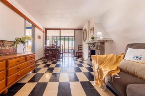 Spacious 2-bedroom apartment in Salou with checkered floors, fireplace, and access to balcony with city views