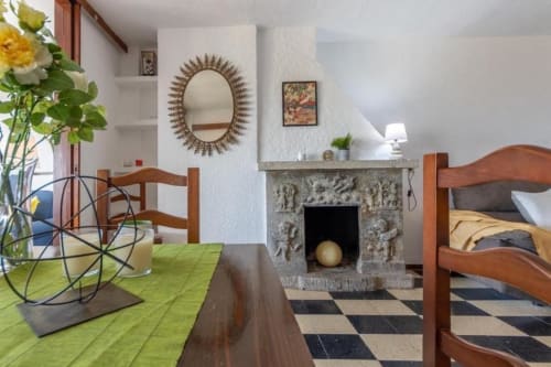 Salou apartment interior with fireplace, wooden furniture, ornate mirror, and green accents