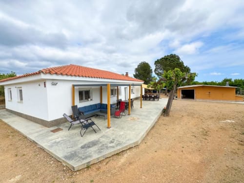 Modern villa at Rentalaya in Reus with terrace, outdoor furniture, and private pool area surrounded by garden views