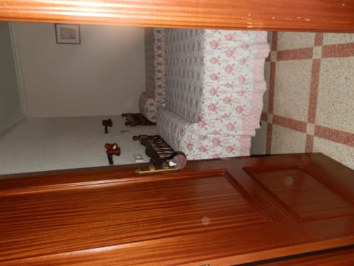 Habitación triple en Hostal San Poul de Consuegra con muebles de madera, ropa de cama estampada y piso de azulejos