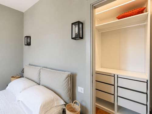 Modern bedroom with built-in wardrobe at Tuscan Townhouse Garden Suite in Montemassi, Italy