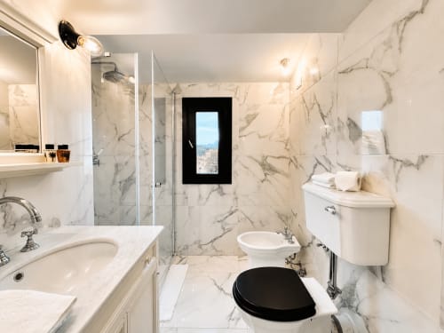 Luxurious marble bathroom in Garden Suite at Tuscan Townhouse B&B, Montemassi with shower and city views