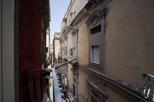 Narrow Neapolitan street view from Calaba apartment in Naples, Italy showing historic buildings and city scenery