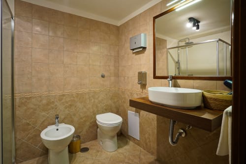 Spacious bathroom in Calaba Decumani apartment, Naples with modern sink, toilet, bidet and walk-in shower