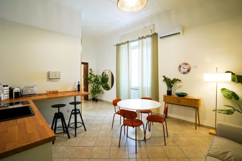 Bright Calaba Decumani apartment in Naples with dining area, workspace, and city views through large windows