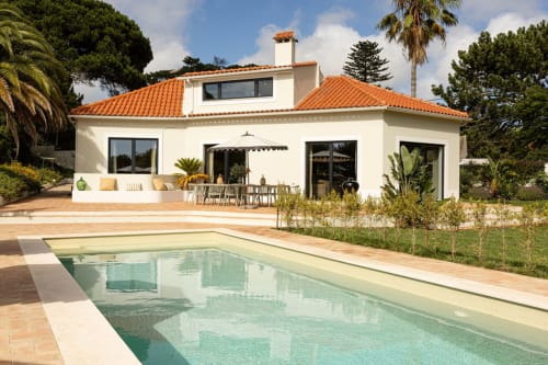 Modern villa at Sea'Ya Villas in Cascais with terracotta roof, pool, patio, and Mediterranean landscape