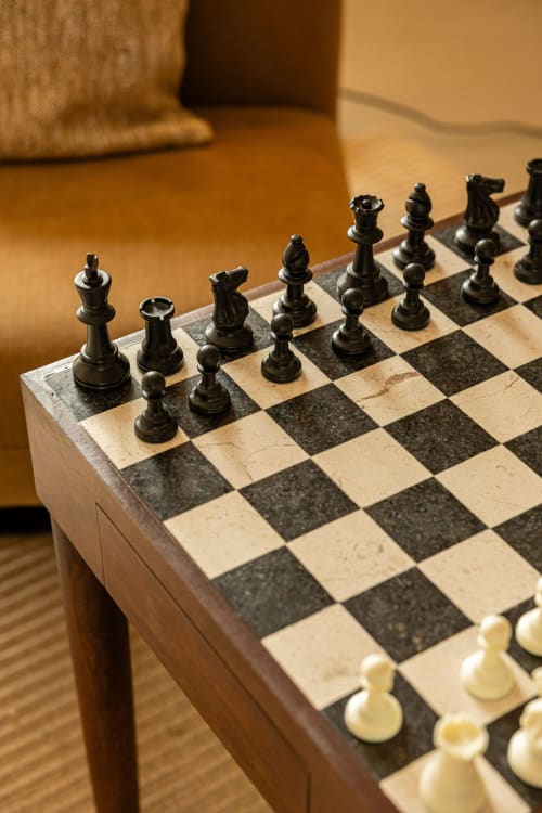 Black and white chess set on marble board at Sea'Ya Villas, Cascais hotel lounge