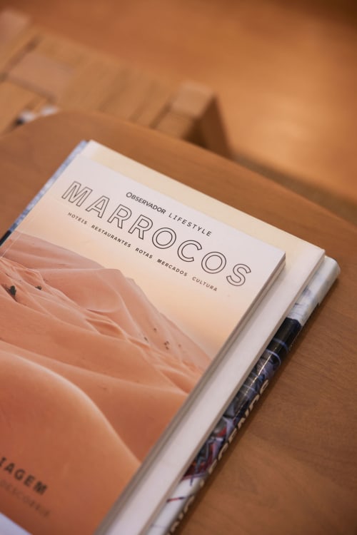 Marroc lifestyle magazine about Cascais hotels, restaurants, and culture on wooden table
