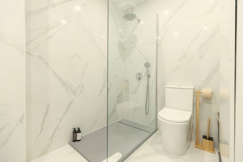 Modern bathroom with marble shower enclosure at Sea'Ya Villas in Cascais, Portugal