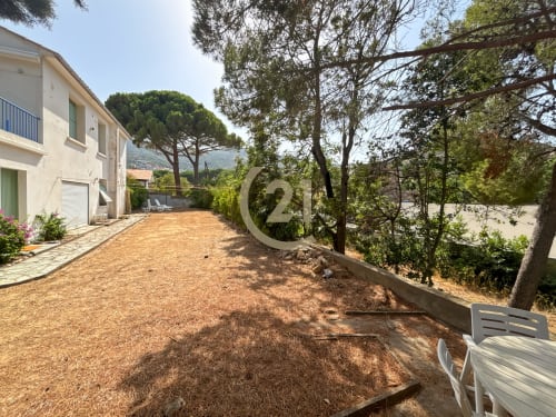 Spacieux jardin-cour de l'appartement à Calvi avec terrasse, arbres et vue sur les montagnes à L'Île-Rousse