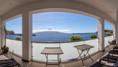 Covered terrace at Suites Avenue Lux with sea views of Mount Pico and Faial harbor, Horta Portugal