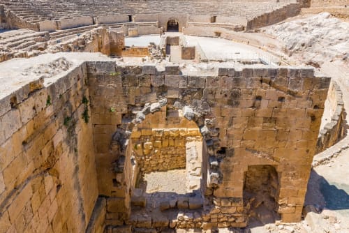 Ancient Roman theater ruins with stone seating and arena floor in Spain