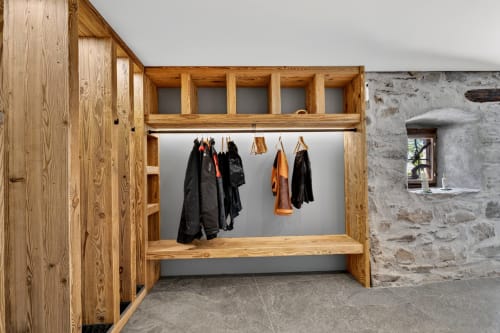 Wooden mudroom with clothing hooks and bench at L'Alp'In, La Plagne Tarentaise