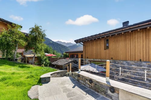 L'Alp'In luxury chalet in La Plagne with mountain views, wooden architecture, and alpine resort amenities