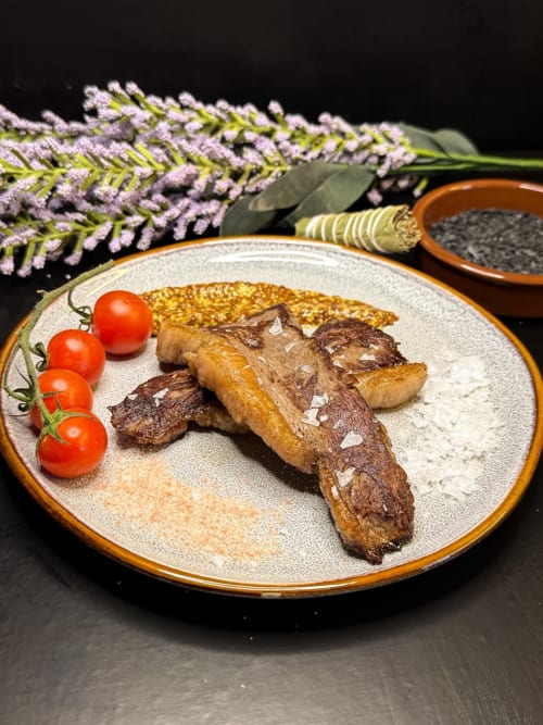 Gourmet plated steak with lavender and tomatoes at La casa de la masia, Susqueda