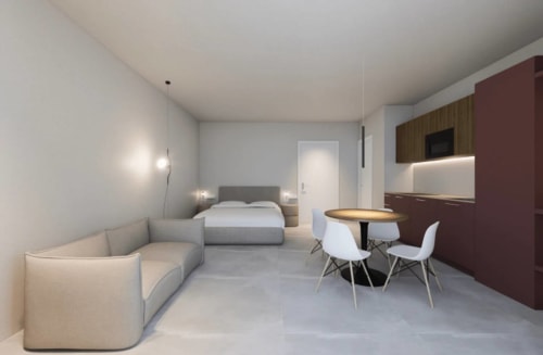 Camera studio moderna presso Vahospitality in Francia con letto, divano, tavolo da pranzo e angolo cottura