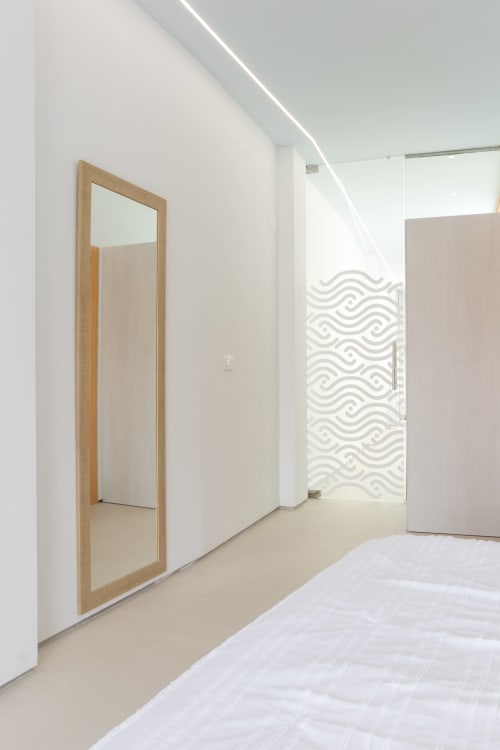 Dormitorio moderno en Ona vacaciones en Gandía con espejo de marco de madera y puerta de ducha con patrón