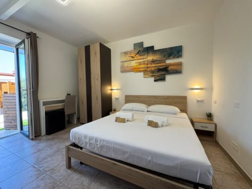 Cleopatra room at Queen Hotel in Campofilone with queen bed, garden view balcony, and modern amenities