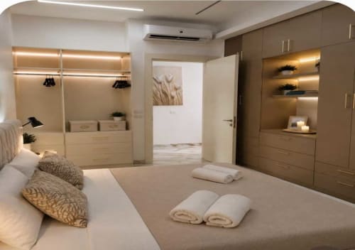 Camera da letto Gold Luxury a Sharm el Sheikh con vista piscina, guardaroba moderno, illuminazione d'atmosfera e asciugamani bianchi