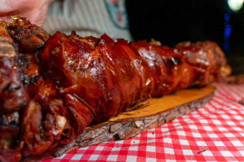 Grilled meat skewers on wooden board at Country House Bosco d'Olmi, Italian countryside BBQ dining