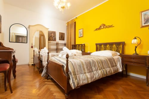 Lussuosa camera a Venezia con letti gemelli, pareti gialle, mobili in legno e vista sulla città - Luxury Loft Venice