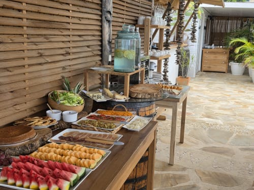 Outdoor buffet spread at Clémara Evasion with fresh fruits, local dishes, and refreshments in Schœlcher, Martinique