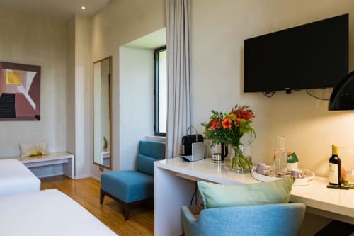 Chambre Huppe du Domaine de la Peyrine à Carignan de Bordeaux avec lits jumeaux, fauteuil bleu, bureau fleuri et