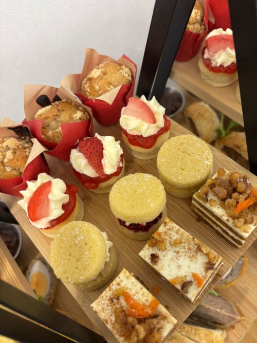 Assorted pastries and desserts displayed on wooden board at The Old Kings Head, Kirton