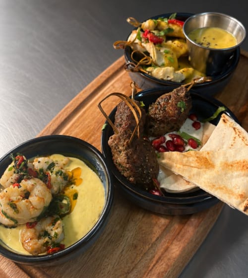 Gourmet plated dishes at The Old Kings Head, Kirton: shrimp curry, beef skewers, grilled vegetables with sauce
